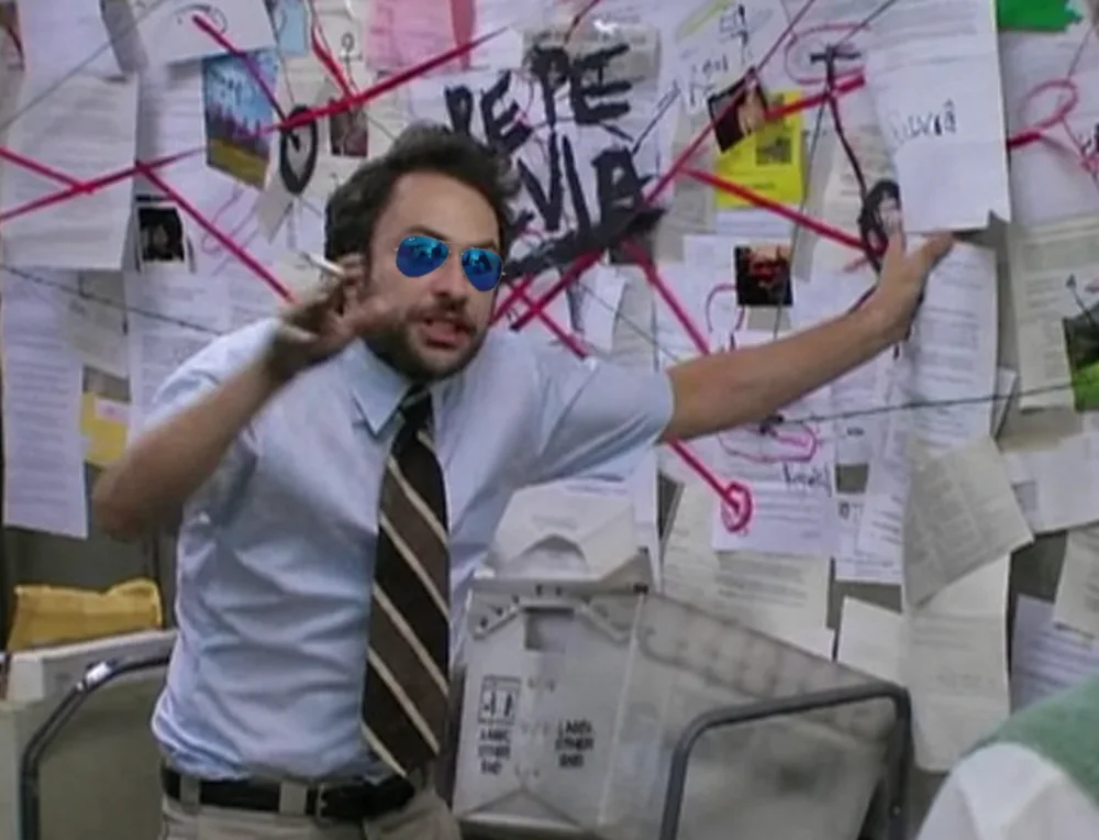 An investigation board covered in papers and red string.